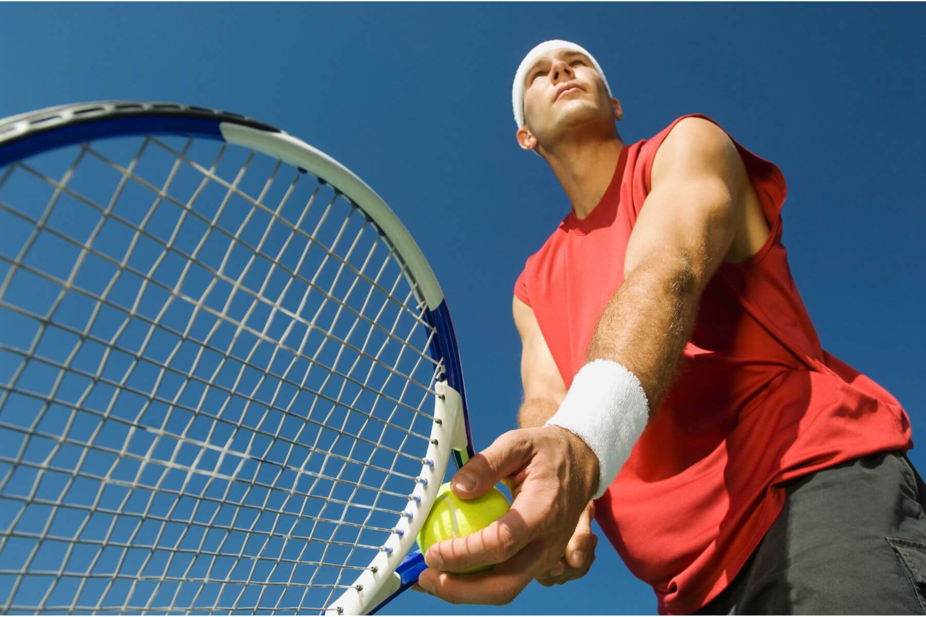 Man attempting tennis serve