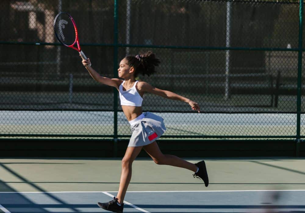 young girl in a beginners tennis class