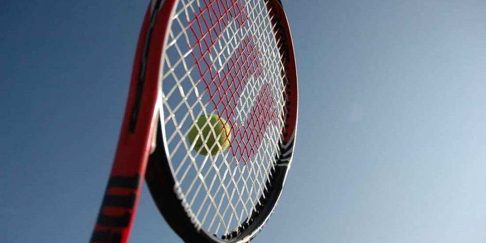 Tennis Racquet close up of tennis racquet hitting a tennis ball
